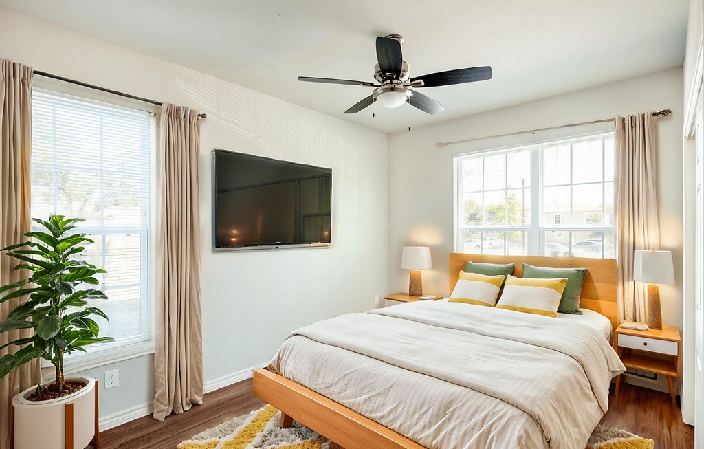 a bedroom with a bed and a ceiling fan