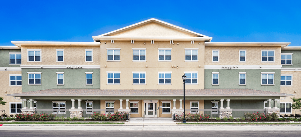 a building with a street light in front of it at Wheatley Park Senior Living Apartments