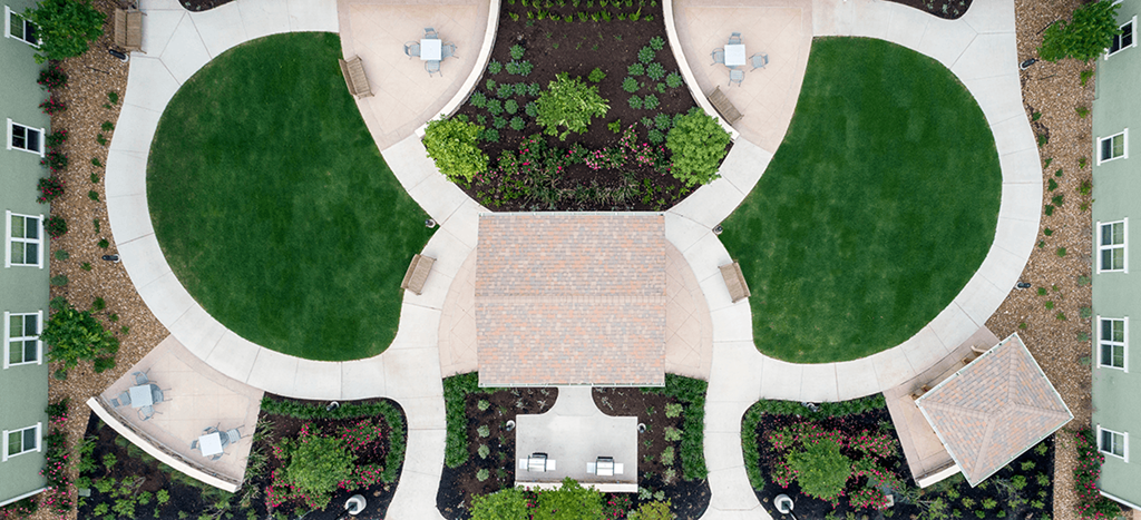 a birds eye view of the courtyard of the Wheatley Park Senior Living Apartments building with grass