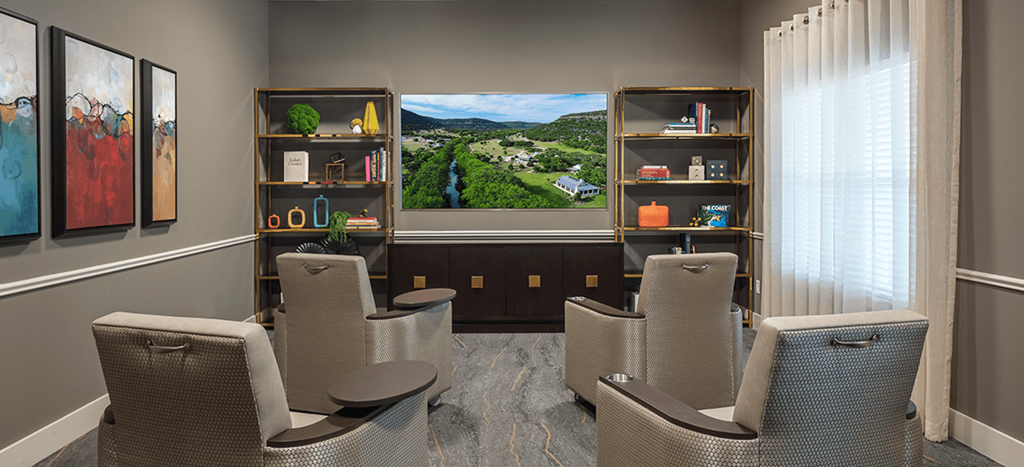 a media room with chairs at Wheatley Park Senior Living Apartments