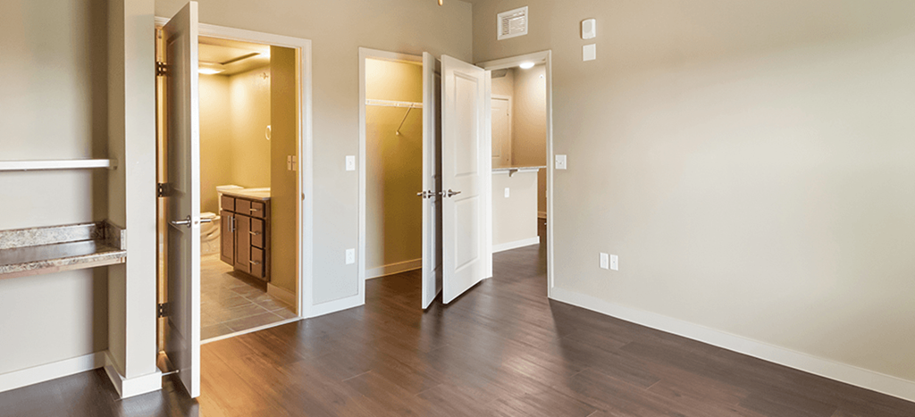 a bedroom with a door open to a bathroom and a closet at Wheatley Park Senior Living Apartments