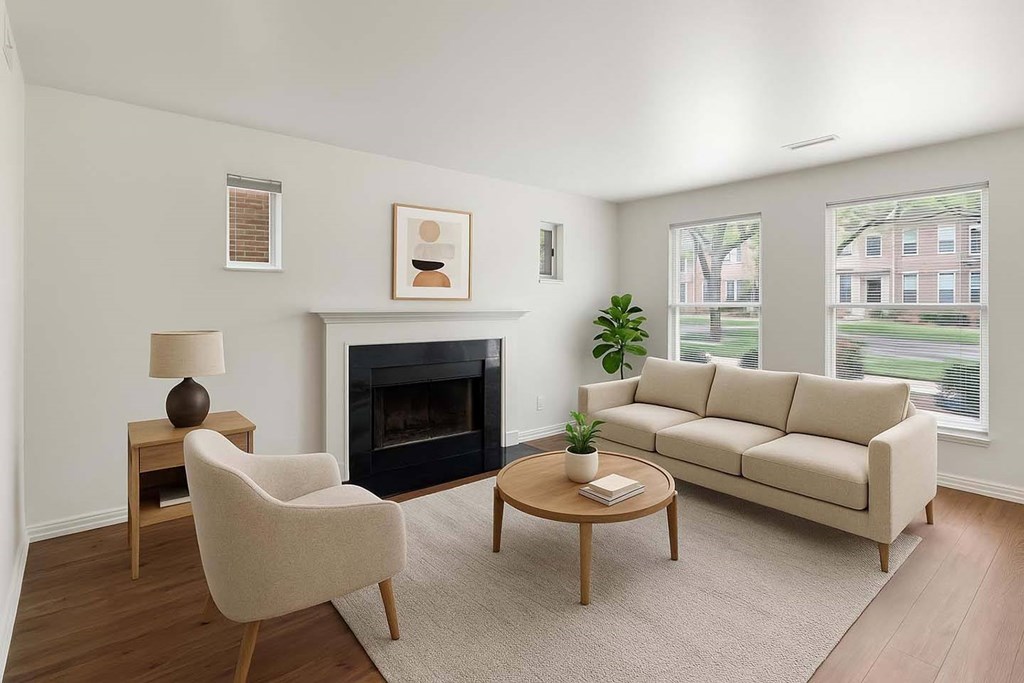 A living room with a fireplace, a chair, a couch, and a table.