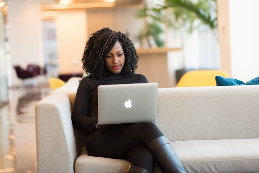 Community Room Woman on laptop sitting on couch