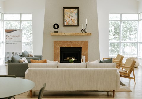 A living room with a fireplace and a painting on the wall.
