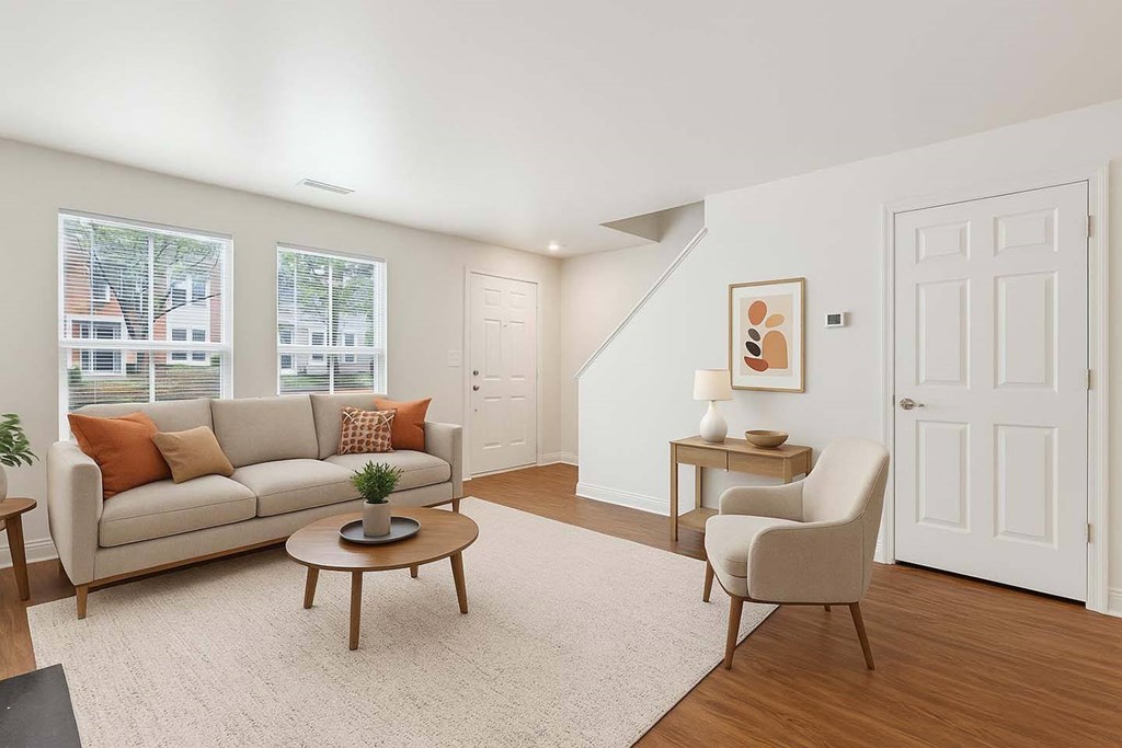 A living room with a couch, chair, and table.
