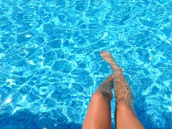 a persons legs in a swimming pool