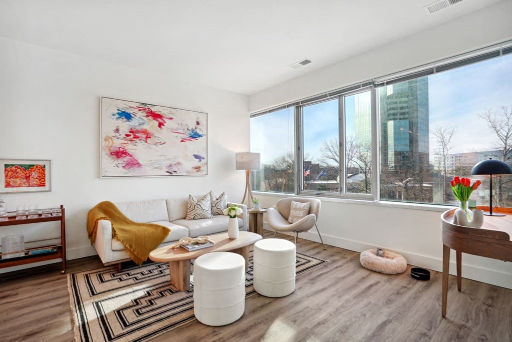 a living room with a couch and a large window at Sinclaire on Seminary, Alexandria, VA