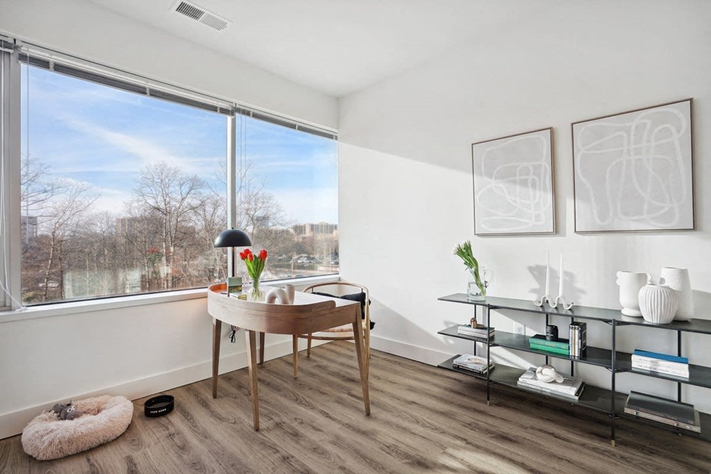 a living room with a large window and a desk at Sinclaire on Seminary, Alexandria