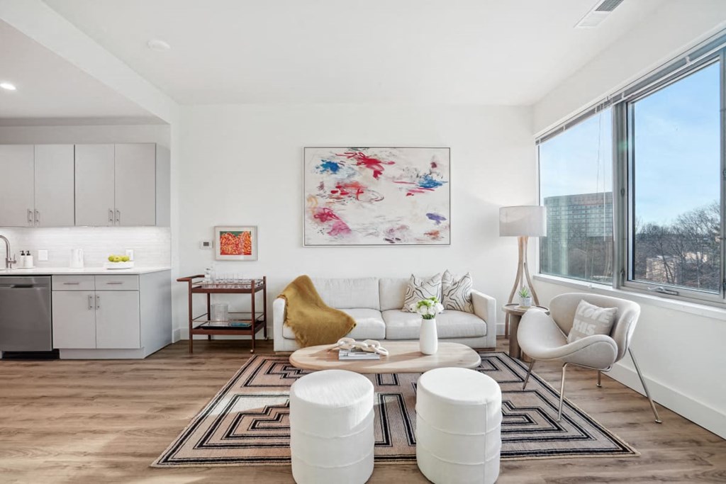a living room with a couch and a large window at Sinclaire on Seminary, Alexandria