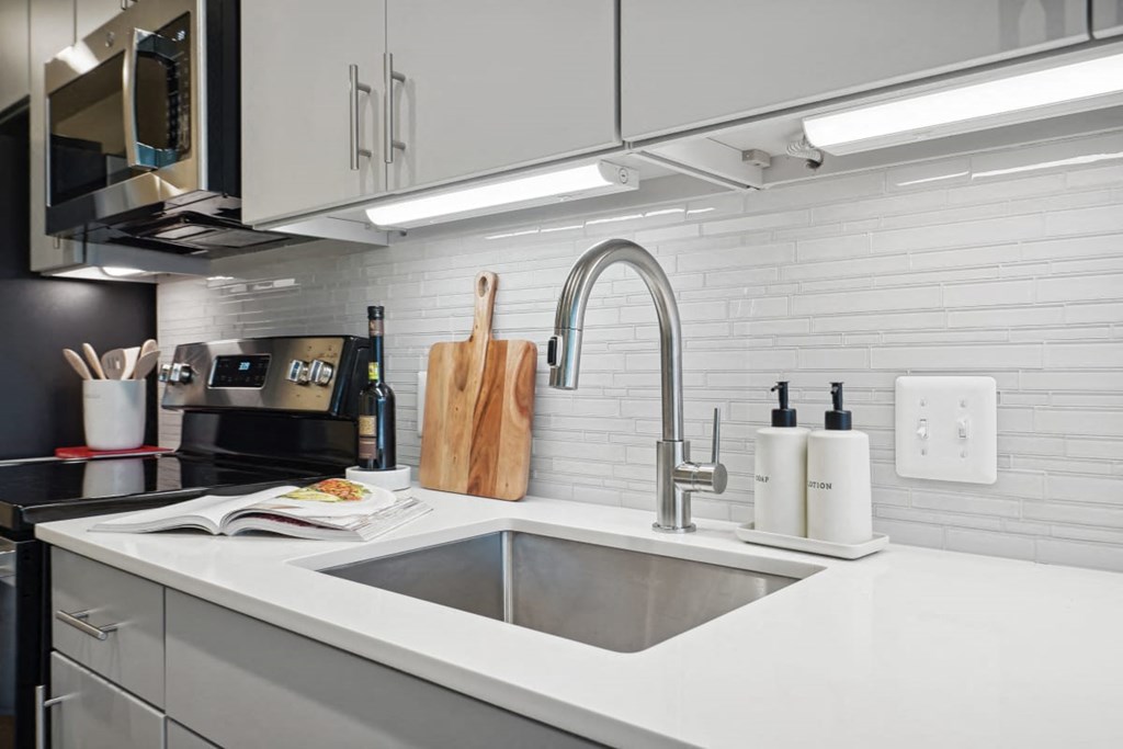 a kitchen with a sink and a microwave at Sinclaire on Seminary, Alexandria, VA 22311