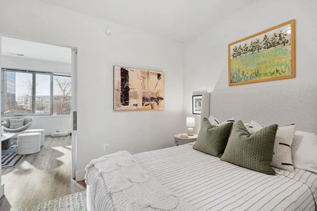 a bedroom with a bed and a bathroom with a window at Sinclaire on Seminary, Alexandria