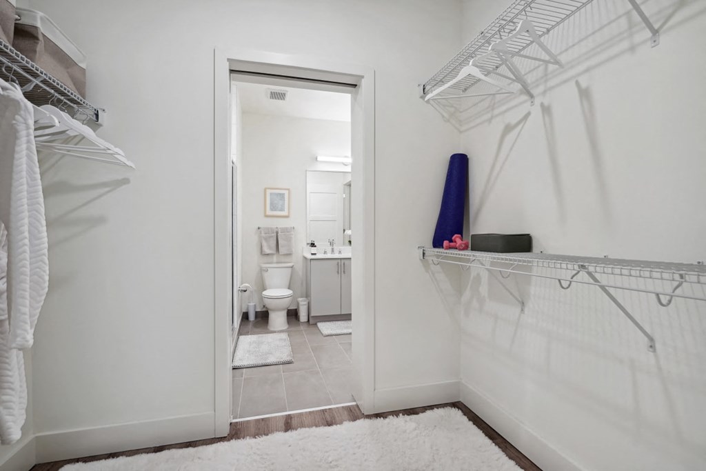 a white bathroom with a white rug and a closet at Sinclaire on Seminary, Alexandria Virginia