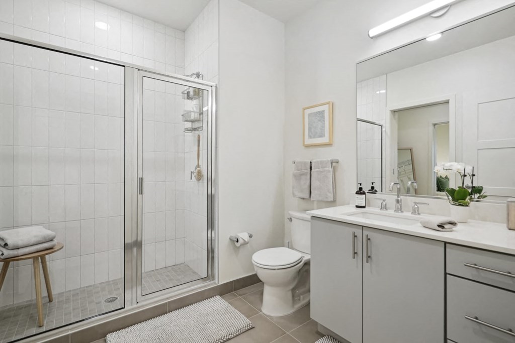 a white bathroom with a shower and a sink at Sinclaire on Seminary, Alexandria Virginia