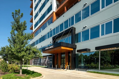 a building with a sidewalk and trees in front of it at Sinclaire on Seminary, Alexandria Virginia