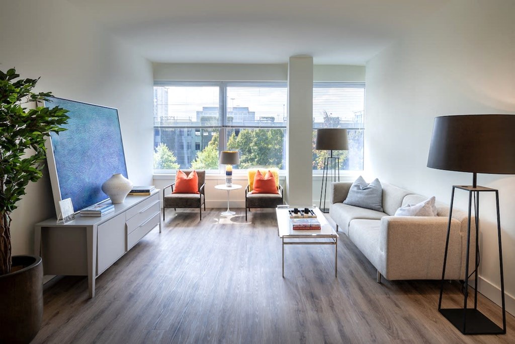 a living room with a couch and a table and a large window at Sinclaire on Seminary, Alexandria, VA