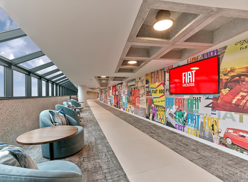 A long hallway with a Fiat House sign on the wall.