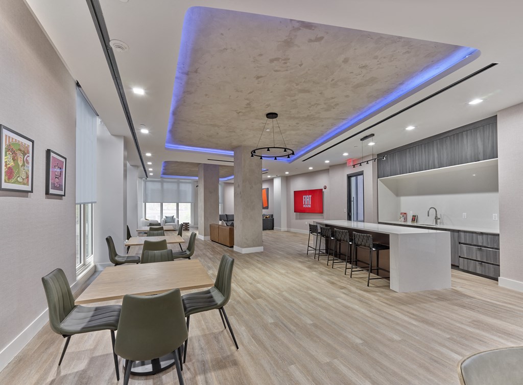 a dining room with tables and chairs and a bar in a lobby