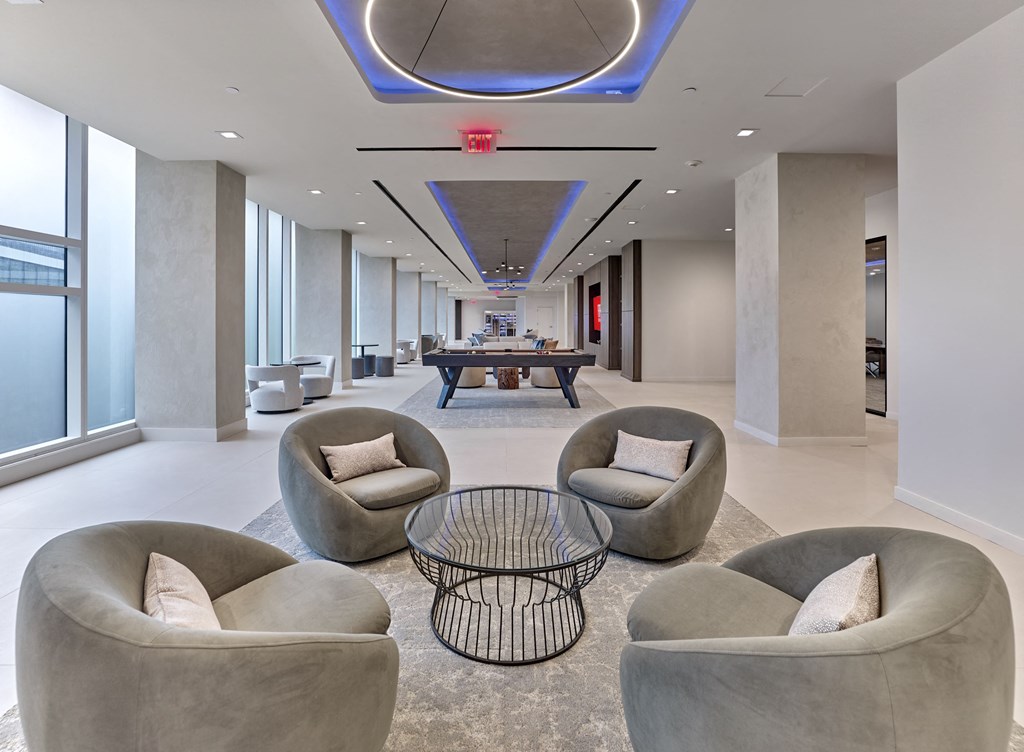 a room with couches and a pool table in the middle