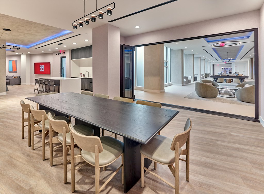 A conference room with a long table and chairs.