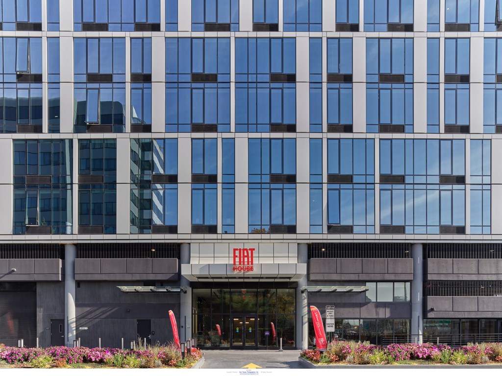 A tall building with a red sign on the entrance.