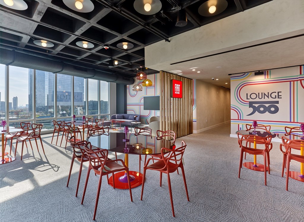 A lounge area with red chairs and a sign that says "LOUNGE".
