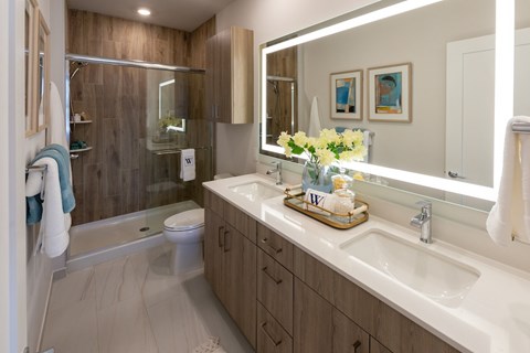 A bathroom with a white sink and a mirror above it.