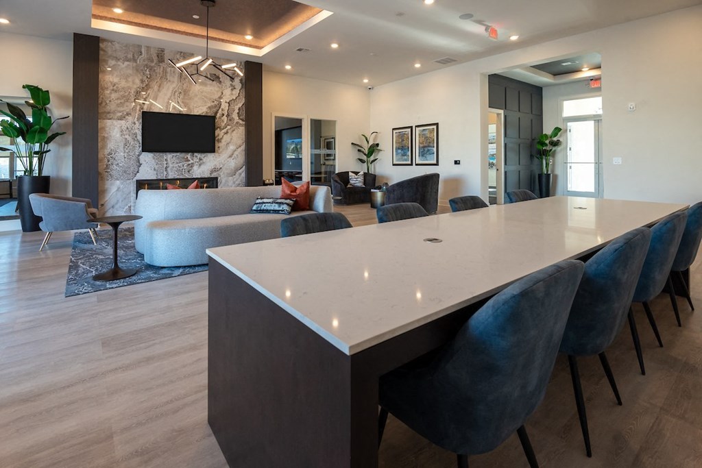 a dining room table and living room with a fireplace