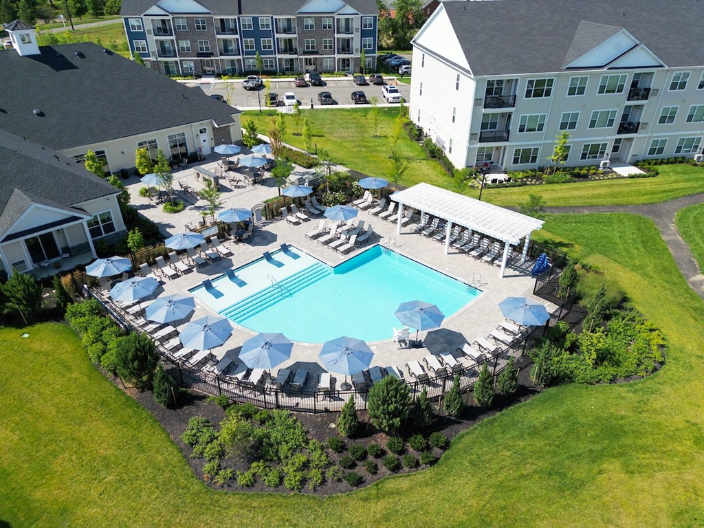 an aerial view of a swimming pool with umbrellas and chairs at the resort