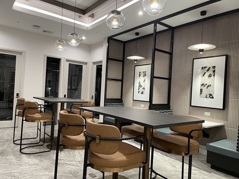 A modern dining room with a long table and chairs.