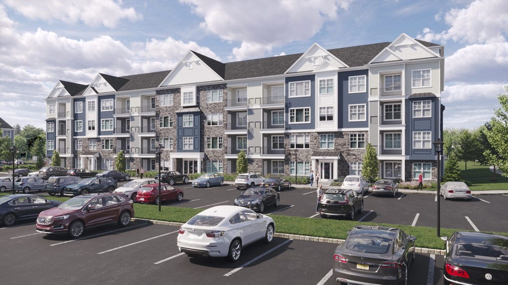 a rendering of an apartment building in a parking lot with cars parked in front of it