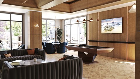 A room with a pool table and a television on the wall.