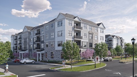 A modern apartment building with a parking lot in front.