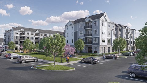 A parking lot with cars and apartment buildings in the background.