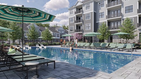 A swimming pool with people relaxing in the sun.