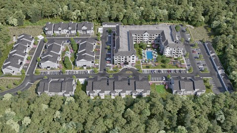 A bird's eye view of a residential complex surrounded by trees.