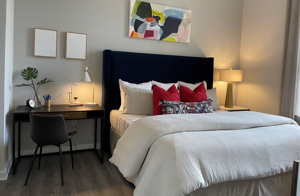 a bedroom with a bed and a desk with a chair