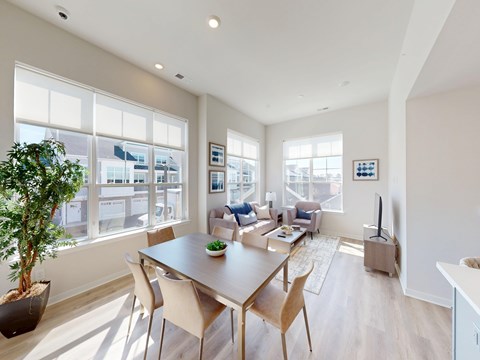 A modern dining room with a large table and chairs.