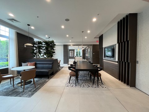 A modern dining room with a black table and chairs.