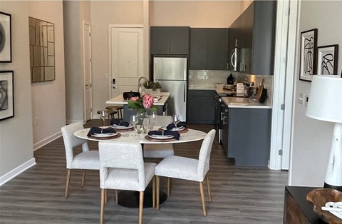 a kitchen and dining room with a table and chairs