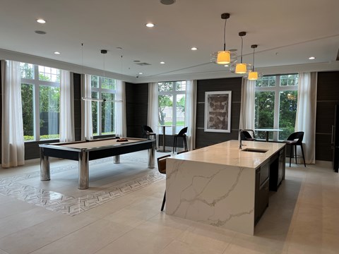 A modern kitchen with a pool table.