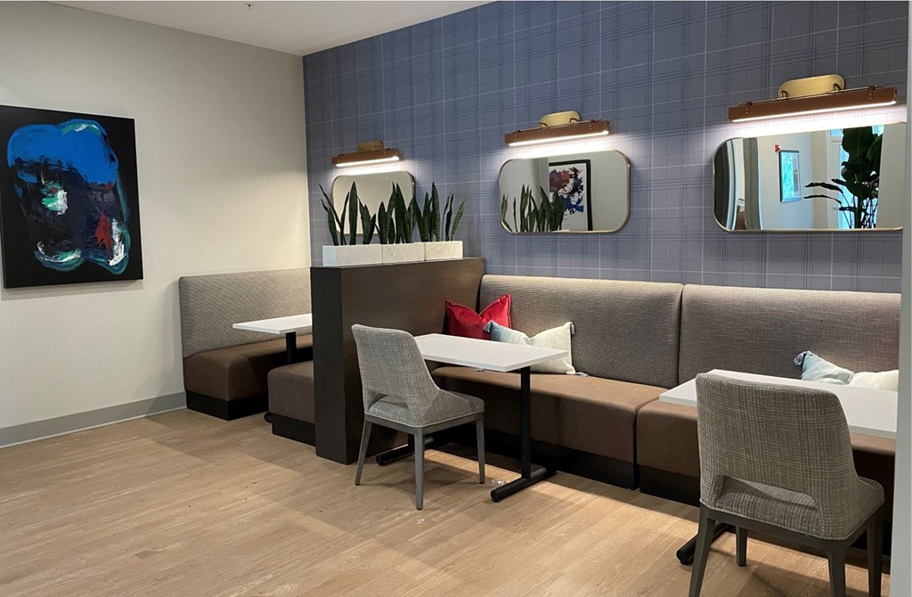 a seating area with two tables and two chairs