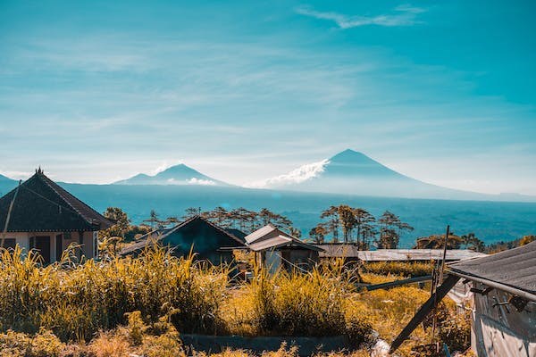a small village with mountains in the background