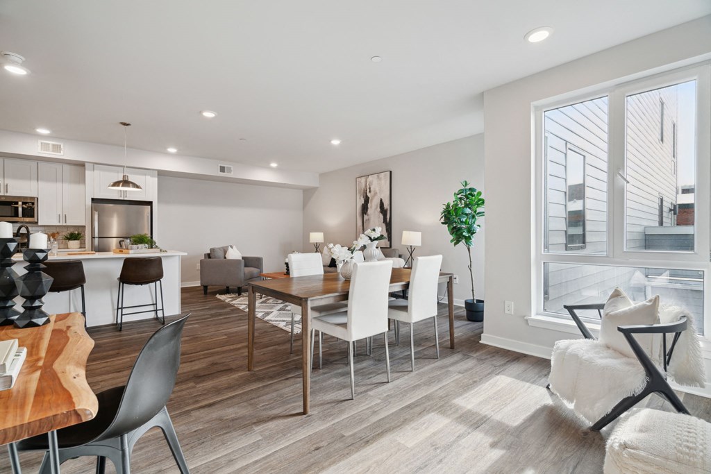 a living room and dining room with a table and chairs
