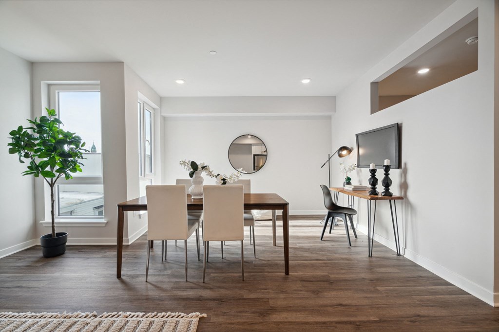 a dining room with a table and chairs and a television