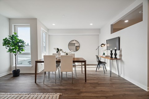 a dining room with a table and chairs and a television