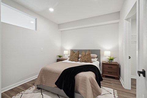 a bedroom with white walls and a bed with pillows
