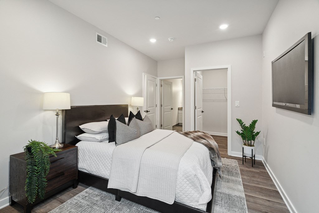 a bedroom with a large bed in front of a tv