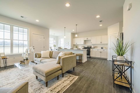 a living room and kitchen with a couch and a table