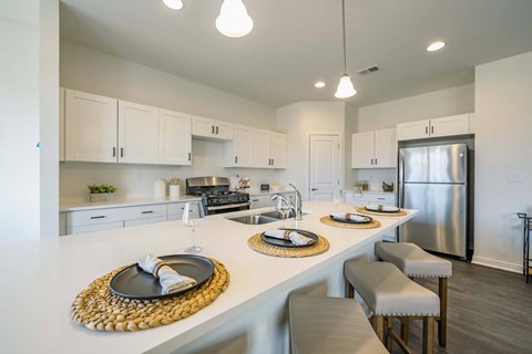 a kitchen with a long counter with plates on it