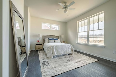 Primary bedroom with large windows and tons of natural light